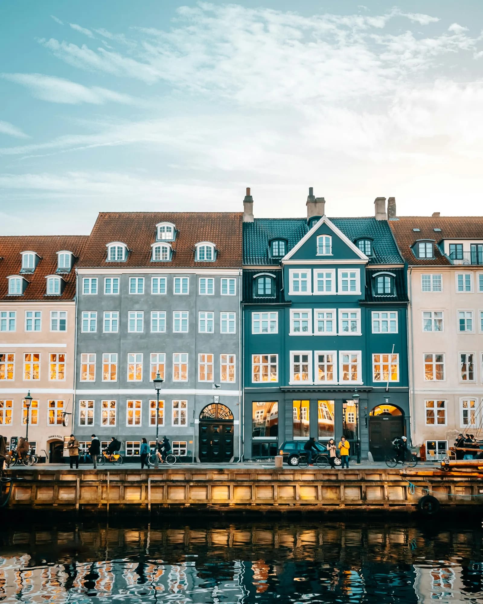 Nyhavn facades at golden hour, reflected in the canal