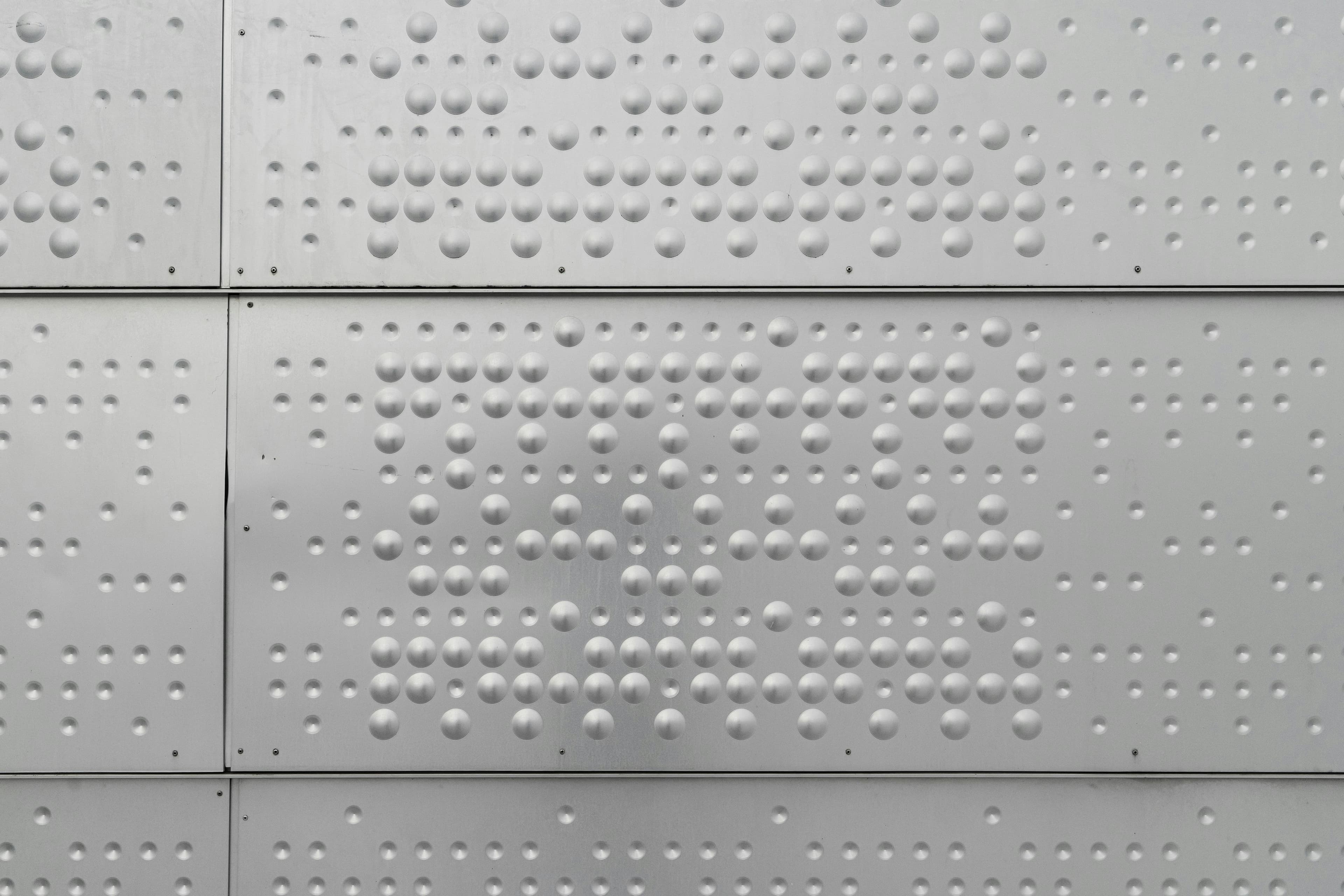Metallic panel with embossed dot pattern